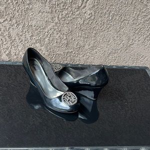 Black pattern leather with silver metal front design. Size 9.5 wedge